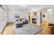 Open living room with hardwood floors, fireplace, decorative columns, couch, and natural light at 3901 Old Atlanta Station Se Dr, Atlanta, GA 30339