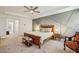 Main bedroom with a gray accent wall, a wooden sleigh bed, and a ceiling fan at 3901 Old Atlanta Station Se Dr, Atlanta, GA 30339