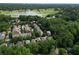 An aerial view displays the neighborhood and houses nestled among a lush green canopy of mature trees and the golf course at 453 Carter Se Ave, Atlanta, GA 30317
