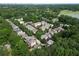 An aerial view displays the neighborhood and houses nestled among a lush green canopy of mature trees at 453 Carter Se Ave, Atlanta, GA 30317