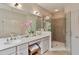 Bathroom with a glass-enclosed shower, double vanity, tile floor, and neutral color scheme at 453 Carter Se Ave, Atlanta, GA 30317