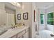 Elegant bathroom with marble countertops, a large mirror, and natural light from bay windows at 453 Carter Se Ave, Atlanta, GA 30317