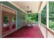 Covered deck with outdoor seating, ceiling fan, and wooded views at 453 Carter Se Ave, Atlanta, GA 30317