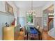 Bright dining room boasts hardwood floors, natural lighting, and stylish chandelier at 453 Carter Se Ave, Atlanta, GA 30317