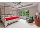 Spacious main bedroom with a ceiling fan, a large window and comfortable seating area at 453 Carter Se Ave, Atlanta, GA 30317