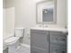 Modern bathroom featuring gray vanity, toilet and shower at 211 Margaret St, Fairburn, GA 30213