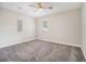 Bedroom with neutral walls, ceiling fan, window and soft gray carpeting at 211 Margaret St, Fairburn, GA 30213