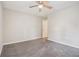 Spacious bedroom with neutral walls, ceiling fan, and soft gray carpeting at 211 Margaret St, Fairburn, GA 30213