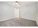 Spacious bedroom with neutral walls, ceiling fan, and soft gray carpeting at 211 Margaret St, Fairburn, GA 30213