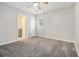 Spacious bedroom with gray carpet, neutral walls, and a view to the en-suite bath at 211 Margaret St, Fairburn, GA 30213