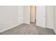 Hallway with neutral walls, and soft gray carpeting at 211 Margaret St, Fairburn, GA 30213