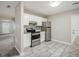 Well-lit kitchen with white cabinets, granite countertops, and stainless steel appliances at 211 Margaret St, Fairburn, GA 30213