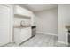 Bright kitchen featuring white cabinets, granite countertops, and stainless steel dishwasher at 211 Margaret St, Fairburn, GA 30213