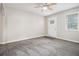 Bright living room with neutral paint, ceiling fan, and a door leading outside at 211 Margaret St, Fairburn, GA 30213