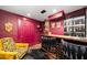 Basement bar area featuring custom dark wood bar, brick accents, and luxurious seating at 486 Haas Se Ave, Atlanta, GA 30316