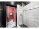 Modern bathroom showcasing a glass-enclosed shower with white marble tiles and gold fixtures at 486 Haas Se Ave, Atlanta, GA 30316
