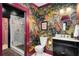 Vibrant bathroom featuring eye-catching wallpaper, a black vanity, and a glass-enclosed shower at 486 Haas Se Ave, Atlanta, GA 30316