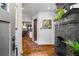 Elegant entryway with hardwood floors, a striking black brick fireplace, and views into the kitchen at 486 Haas Se Ave, Atlanta, GA 30316