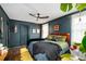 Stylish main bedroom featuring dark blue walls, hardwood floors, ceiling fan, and a cozy, inviting atmosphere at 486 Haas Se Ave, Atlanta, GA 30316