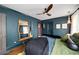 Stylish main bedroom featuring dark blue walls, hardwood floors, ceiling fan, and a cozy, inviting atmosphere at 486 Haas Se Ave, Atlanta, GA 30316