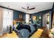 Stylish main bedroom featuring dark blue walls, hardwood floors, ceiling fan, and a cozy, inviting atmosphere at 486 Haas Se Ave, Atlanta, GA 30316