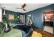 Stylish main bedroom featuring dark blue walls, hardwood floors, ceiling fan, and a cozy, inviting atmosphere at 486 Haas Se Ave, Atlanta, GA 30316