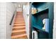 Unique staircase with wooden stairs and a custom blue bookcase showcasing unique decorative items at 486 Haas Se Ave, Atlanta, GA 30316