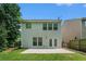 Home's rear exterior with a well-maintained lawn and a concrete patio at 85 Brushed Ives Ct, Lawrenceville, GA 30045