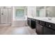 Elegant bathroom with dual vanities, soaking tub, and separate glass-enclosed shower at 85 Brushed Ives Ct, Lawrenceville, GA 30045