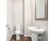 A clean, well-lit powder room with a pedestal sink and modern fixtures at 85 Brushed Ives Ct, Lawrenceville, GA 30045