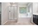 Bright bathroom featuring a shower, soaking tub, and neutral accents at 85 Brushed Ives Ct, Lawrenceville, GA 30045