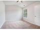 Empty bedroom featuring large window, plush carpet, and closet at 85 Brushed Ives Ct, Lawrenceville, GA 30045