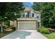 Charming two-story home featuring a stone facade and a well-maintained front yard with lush landscaping at 85 Brushed Ives Ct, Lawrenceville, GA 30045