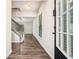 Inviting foyer with hardwood floors, staircase, and natural light streaming through the front door at 85 Brushed Ives Ct, Lawrenceville, GA 30045