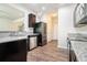 Modern kitchen featuring stainless steel appliances, granite countertops, and hardwood floors at 85 Brushed Ives Ct, Lawrenceville, GA 30045