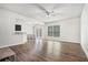 Bright open-plan living room featuring hardwood floors, a ceiling fan, and sliding glass doors to the backyard at 85 Brushed Ives Ct, Lawrenceville, GA 30045