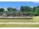 Community playground with a variety of play structures set in a grassy area at 85 Brushed Ives Ct, Lawrenceville, GA 30045
