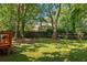 The back yard offers a grassy lawn and a mature tree canopy to provide shade at 901 Winfield Se Ave, Atlanta, GA 30316