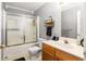 Bathroom with a sink, wood cabinets, mirror, and shower-tub combination behind a sliding glass door at 901 Winfield Se Ave, Atlanta, GA 30316