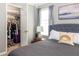 Cozy bedroom with a walk-in closet, carpeted floor, window with curtains, and comfortable bed at 901 Winfield Se Ave, Atlanta, GA 30316
