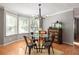 Bright dining room featuring a modern chandelier, bay windows, hardwood floors and neutral color scheme at 901 Winfield Se Ave, Atlanta, GA 30316
