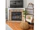 Close up on a fireplace with tile surround, plus comfortable chair and modern decor at 901 Winfield Se Ave, Atlanta, GA 30316