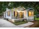 Cozy home featuring a bright yellow front door, bay windows, and covered front porch seating area at 901 Winfield Se Ave, Atlanta, GA 30316