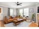 Comfortable living room with hardwood floors, a ceiling fan, large windows, and modern decor at 901 Winfield Se Ave, Atlanta, GA 30316
