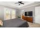 Spacious main bedroom featuring a ceiling fan, ensuite bath access, and french door access to the back deck at 901 Winfield Se Ave, Atlanta, GA 30316
