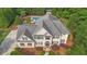 Expansive aerial view showcasing the beautiful home, lush landscaping, driveway, and inviting pool area at 104 Hidden Springs Ln, Peachtree City, GA 30269