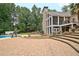 Expansive backyard features a multi-level stone patio, lush landscaping, and a sparkling pool, perfect for outdoor entertaining at 104 Hidden Springs Ln, Peachtree City, GA 30269