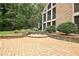 Inviting backyard features a stone patio with seating, lush greenery, and mature trees, ideal for outdoor gatherings at 104 Hidden Springs Ln, Peachtree City, GA 30269