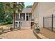 Backyard features a stone patio with outdoor stairs to a screened porch and swimming pool at 104 Hidden Springs Ln, Peachtree City, GA 30269