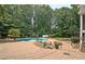 Lush backyard with a large pool, a brick paver patio, and ample green space at 104 Hidden Springs Ln, Peachtree City, GA 30269